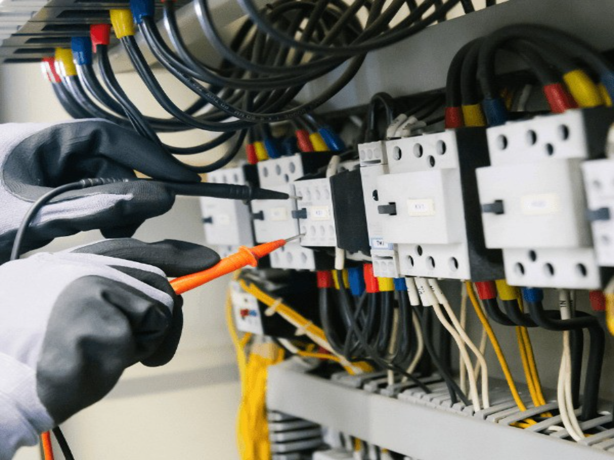 electrician-testing-electrical-panel-with-multimeter-.jpg Electrician testing electrical panel with multimeter.